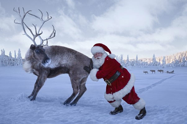 Santa pushing reindeer
